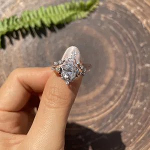 Detail shot of oval moissanite stacking rings with star and moon motifs on a finger