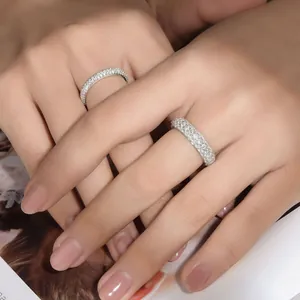 Close-up of sparkling pave-set moissanite eternity rings in S925 silver on fingers