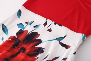 Close-up of vibrant red floral print and color blocking on a women's dress fabric detail