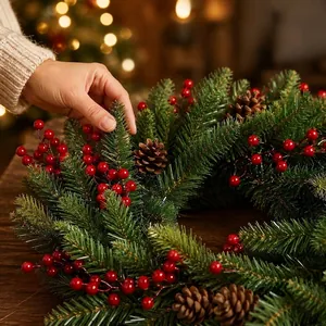 Close-up detail of a handcrafted Christmas wreath with pine cones and red berries