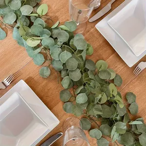 Detailed view of realistic artificial eucalyptus leaf garland used as table runner