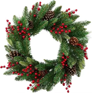Christmas wreath with artificial pine needles, realistic pine cones and vibrant red berries