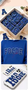 Detailed macro view showing the plush texture of blue chenille alphabet patches with gold