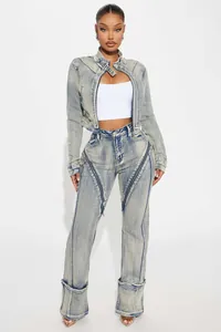 Washed blue denim jacket and pants set with unique diagonal zipper details on model