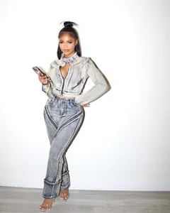 Trendy two-piece acid wash denim jacket and flared pants set featuring zipper accents
