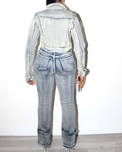 Back view of a light acid wash denim cropped jacket and high-waisted jeans set.