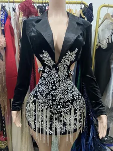 Detailed view of black velvet blazer dress featuring rhinestone flowers and long tassels.