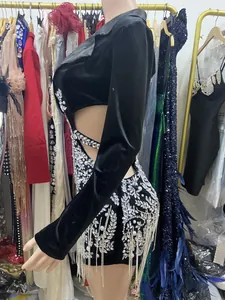 Detailed view of rhinestone fringe and leaf patterns on a black velvet suit dress