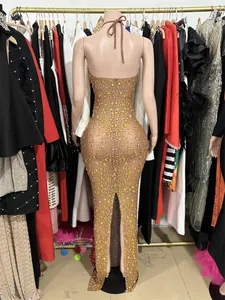 Back view detail of a sparkling yellow rhinestone nude mesh backless evening dress