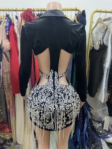 Detail view of backless black velvet dress with heavy rhinestone and pearl fringe