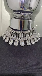 Close-up of sparkling rhinestone collar on a slim-fit black bandage evening dress