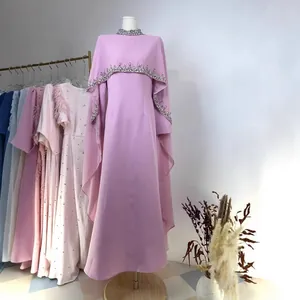 Elegant pink floor-length evening dress with rhinestone-beaded shawl cape detail.