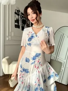 Élégante robe fleurie blanche à col en V avec ourlet à volants et taille cintrée pour vacances