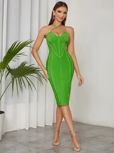 Detail of vibrant green crisscross halter bodycon dress showing corset-style bodice.