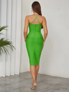 Back view of a sexy green cross-halter bodycon midi dress with zipper detail.