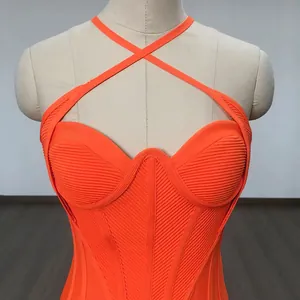 Macro detail of vibrant orange cross halter bandage dress with intricate ribbed texture