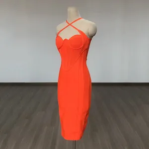 Side view of vibrant orange bodycon bandage dress with criss-cross halter neckline