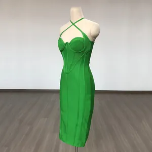 Detail view of green crisscross halter bodycon bandage dress with corset bodice structure.