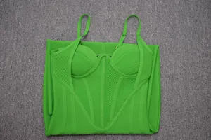 Macro detail of high-quality green ribbed bandage dress with structured corset bustier.