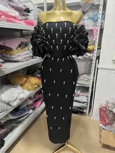 Elegant black off-shoulder bandage dress with pearl embellishments and ruffled puff sleeves.