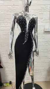 Elegant black evening gown with heavy rhinestone embellishments, plunging V-neck and high slit