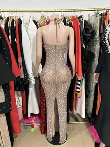 Rear view of a nude mesh evening dress with sparkling rhinestones and halter neck design