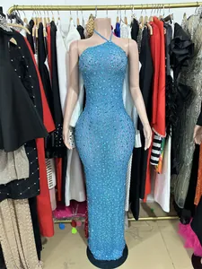 Full-length view of a luxurious sparkling light blue rhinestone mesh evening gown on a mannequin
