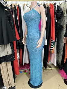 Detail view of heavy sparkling blue rhinestones on a mesh backless evening party gown.