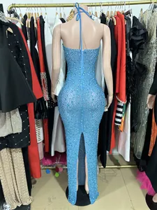 Back view of a sparkling blue rhinestone evening gown with mesh and backless design.