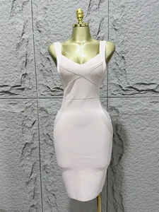 Elegant light pink bandage bodycon dress featuring a criss-cross V-neck design on a mannequin