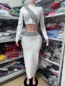 Detailed view of white long-sleeve crop top and rhinestone skirt set on mannequin