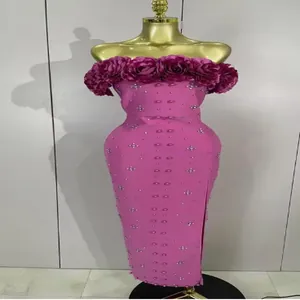 Detail of pink off-shoulder bandage dress with 3D floral trim and pearl embellishments.
