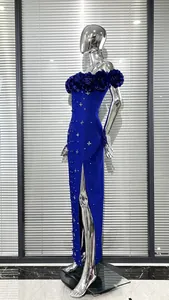 Close-up side view of a royal blue bandage dress with 3D floral neckline and pearls