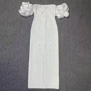 Macro detail of elegant white bodycon maxi dress with puffy sleeves and rhinestones