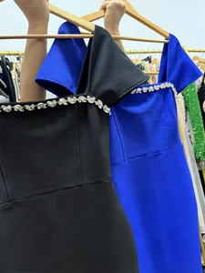 Close-up detail of the elegant rhinestone neckline on a slim-fit off-shoulder dress.