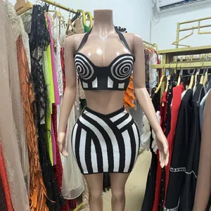 Sexy black and white striped two-piece set with backless crop top and mini skirt.