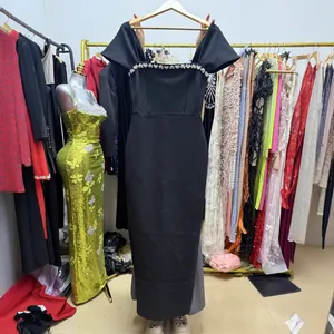 Elegant black off-shoulder maxi dress with rhinestone detailing and bodycon fit.