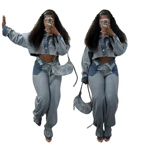 Detail view of a color-block denim set featuring a cropped jacket and baggy pants.