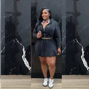 Full body view of women's washed black denim jacket and pleated skirt set on model