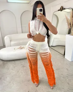 Stylish two-piece women set with white knot crop top and orange gradient fringe wide leg pants.