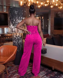 Rear view of a chic washed magenta strapless jumpsuit featuring elegant wide legs