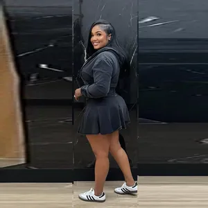 Detailed view of women's washed black denim hoodie and pleated skirt set.