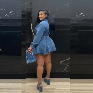 Rear view detail of casual washed denim two-piece outfit with pleated mini skirt and jacket