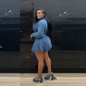 Full body side view of a stylish blue washed denim jacket and pleated mini skirt set