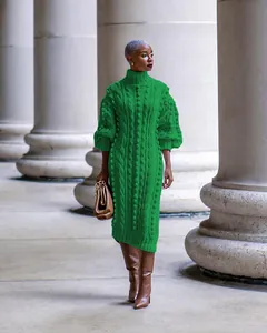 Detailed street style view of a green cable knit high neck dress on a fashion model