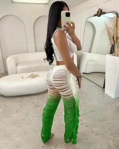 Two-piece set with white sleeveless crop top and green gradient hollow-out fringed pants.