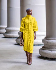 Detailed look at the elegant yellow cable knit texture on a high neck long dress