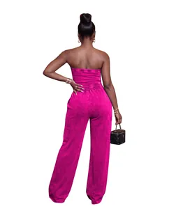 Back view of a vibrant pink strapless washed jumpsuit with wide-leg and elastic waist