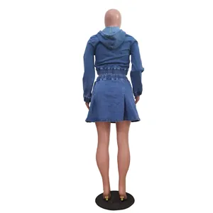Back view of a two-piece washed denim set with hooded jacket and pleated skirt