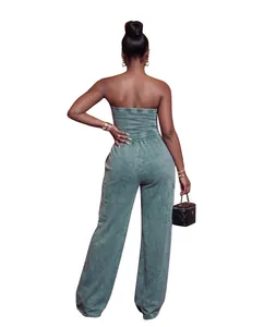 Back view of a washed green strapless wide-leg jumpsuit on a model